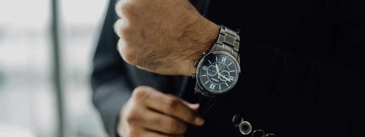 Fossil ur i stål med mørk skive på model