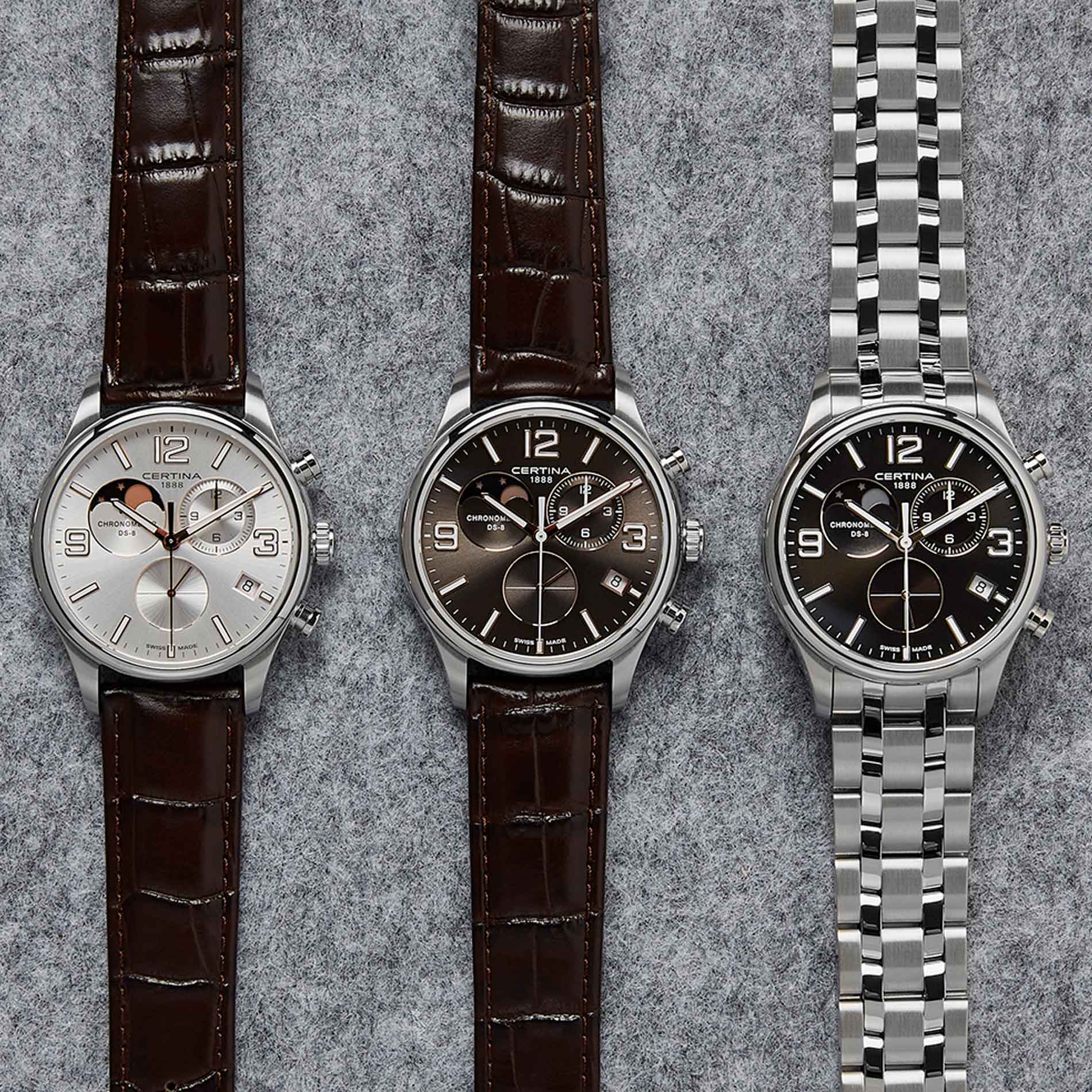 Certina DS 8 Moon Phase herreur med brun skive og brun læderrem, ved siden af andre ure fra samme serie