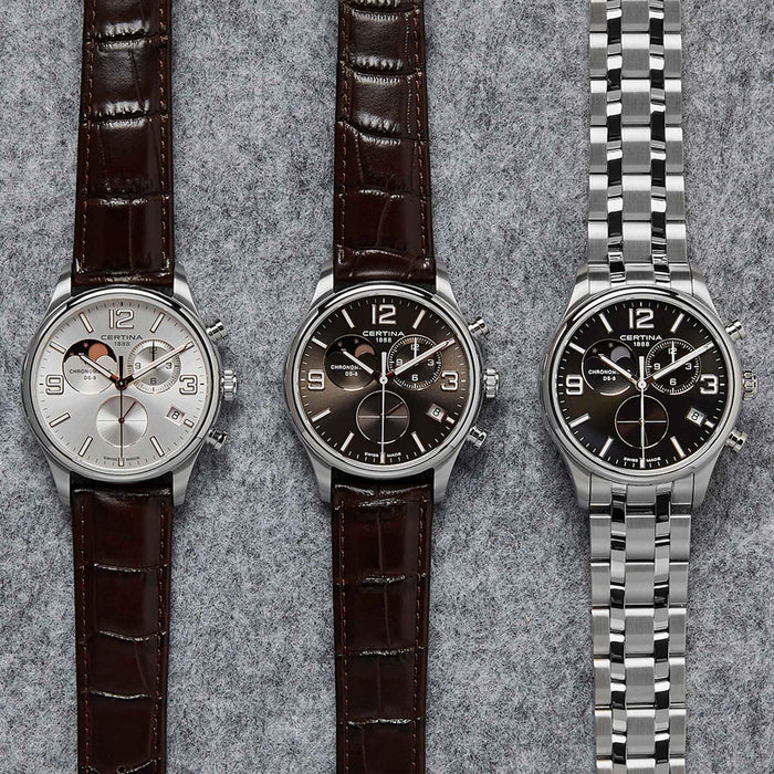 Certina DS 8 Moon Phase herreur med brun skive og brun læderrem, ved siden af andre ure fra samme serie