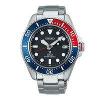 Seiko herreur i stål med sort urskive og blå / rød krans. Uret ses forfra.