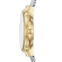 Skagen dameur i stål med meshlænke, funklende sten og guldfarvet urkasse. Uret ses fra siden.