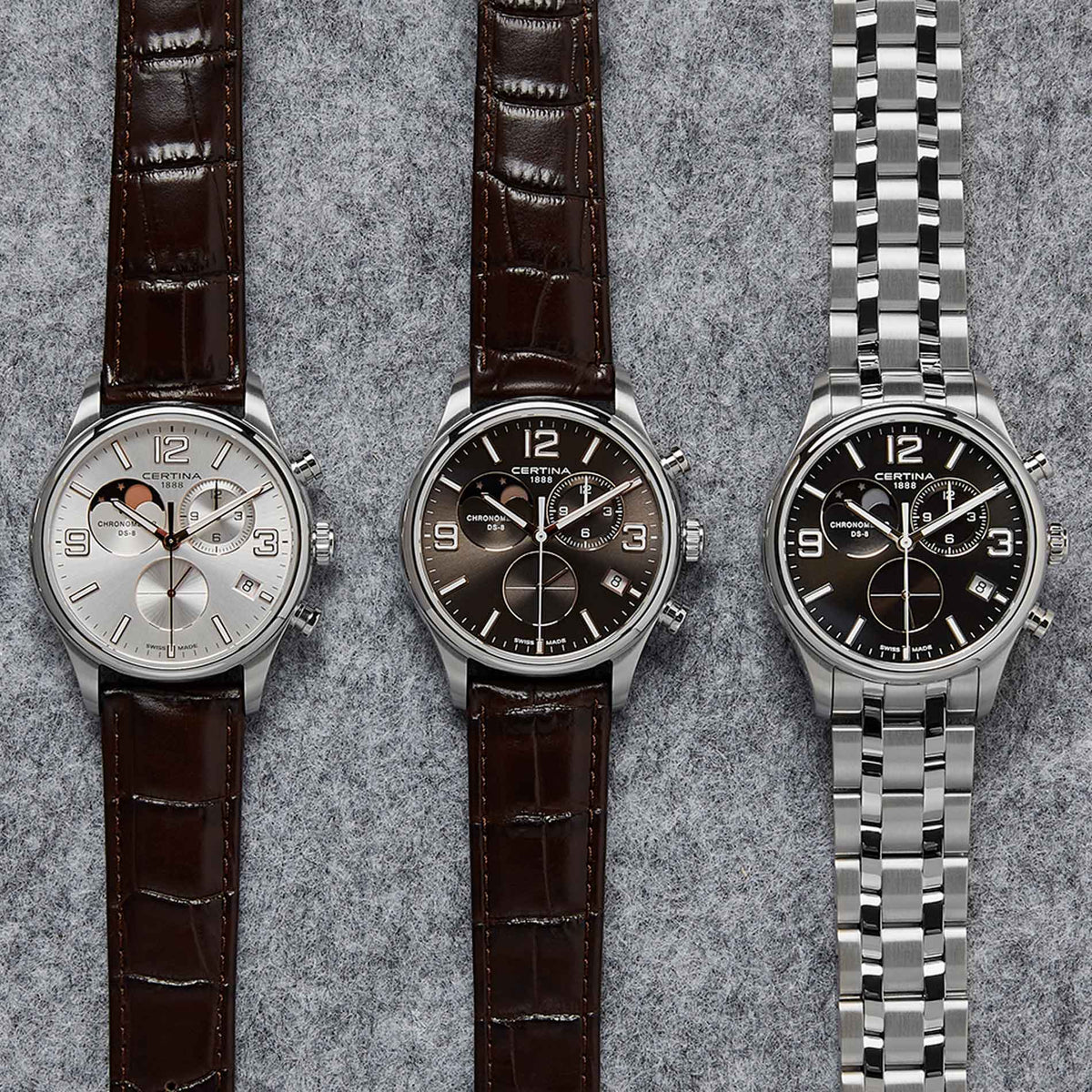 Certina DS 8 Moon Phase herreur med brun skive og brun læderrem, ved siden af andre ure fra samme serie