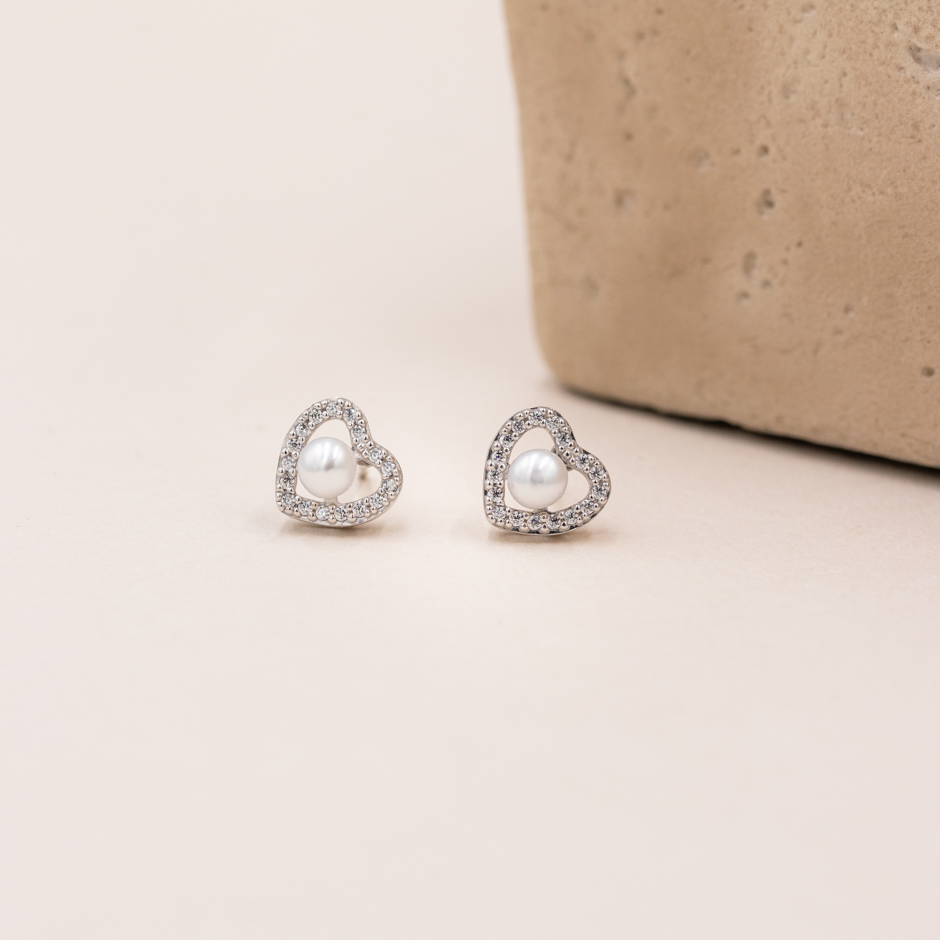 Hjerteformede sølv ørestikker med zirkonia i elegant opstilling