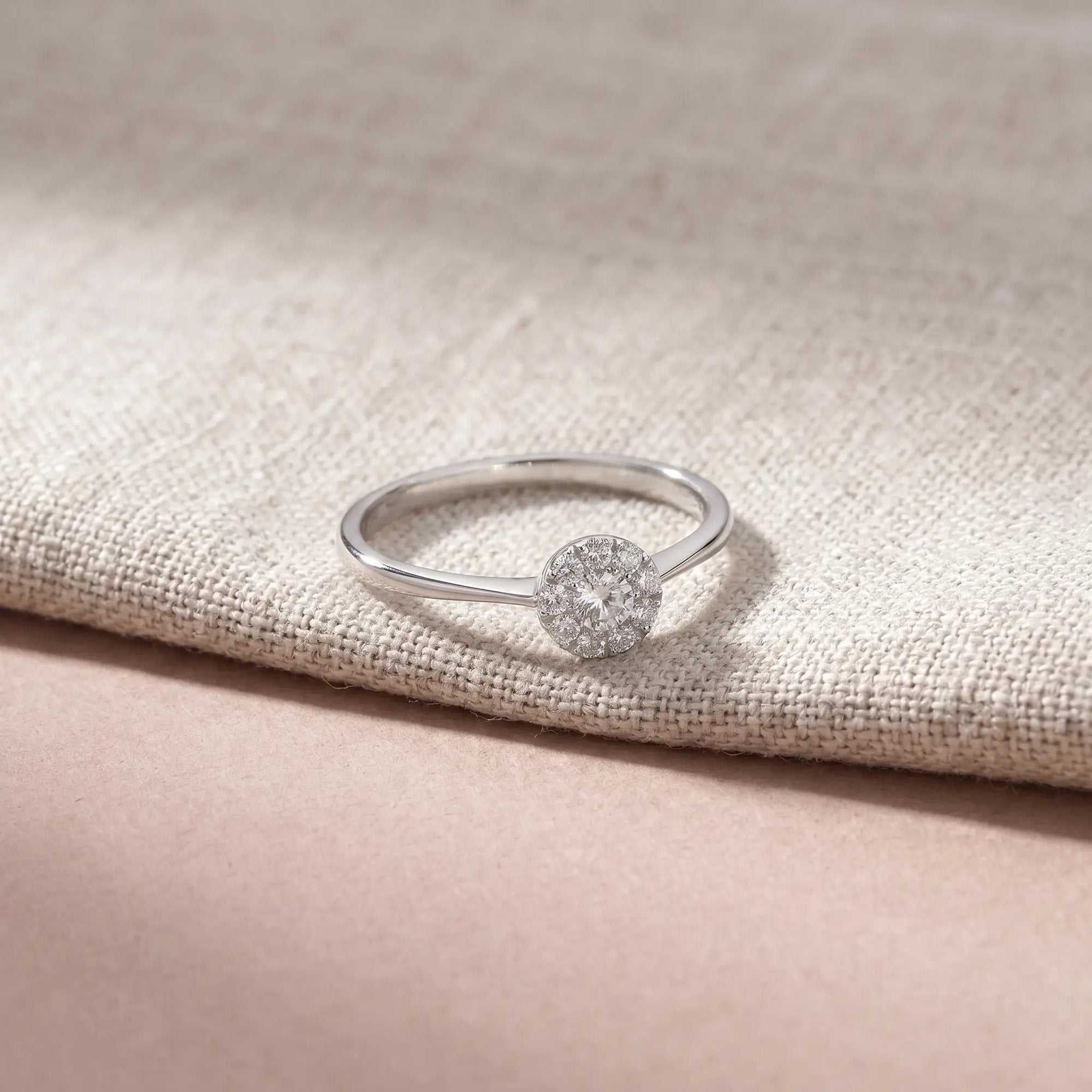 Alma ring i hvidguld med 0,20 carat diamanter på lyst hørstof