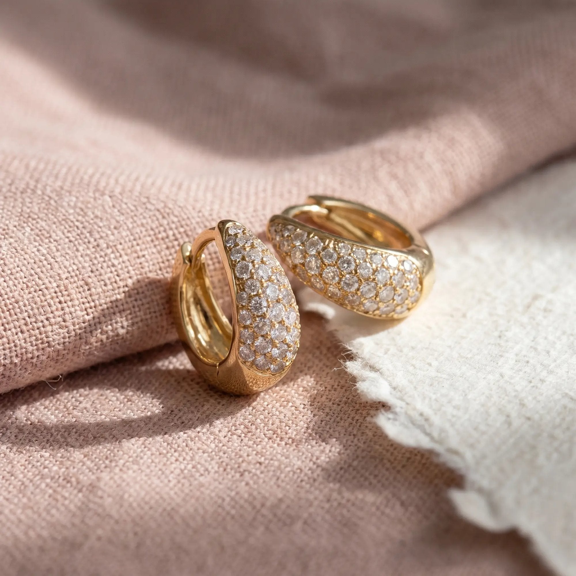 Ella hoops i guld med 0,63 carat diamanter på lyserødt stof